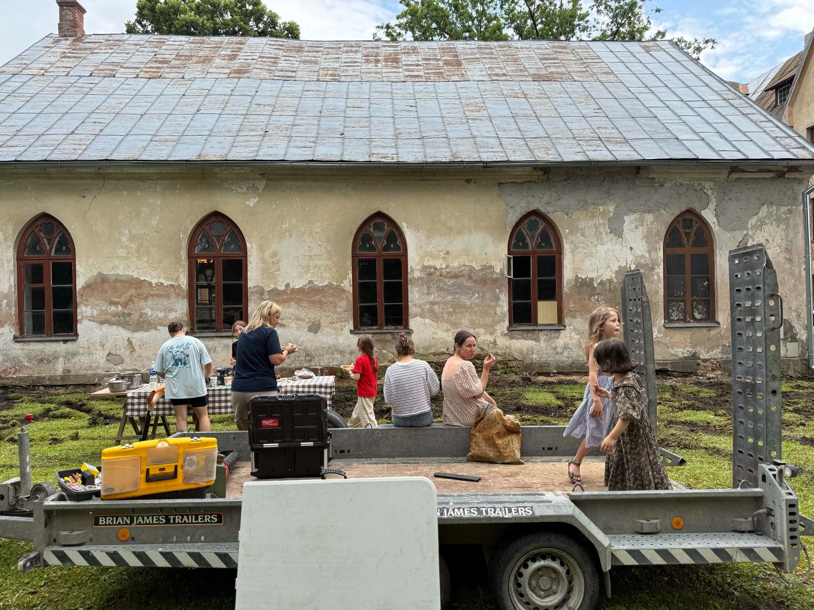 Families sharing lunch beside the old church